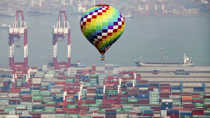A hot-air balloon flies over a container port in Qingdao in east China's Shandong province Sunday, Sept. 9, 2012. Asia-Pacific leaders focused their attention on rising concern over food security on Sunday, as they prepared to wrap up their annual summit with an agreement to slash tariffs on trade in environmental goods and a call to keep markets open even in hard times. (AP Photo