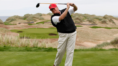 Donald Trump swings a golf club in Scotland.