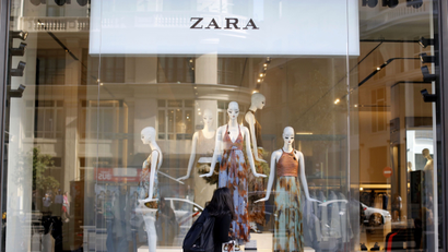 A woman looks at a display window in a Zara store in Madrid, Spain, June 15, 2016. REUTERS/Paul Hanna - S1AETKAGOEAA