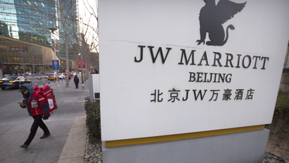 A deliveryman walks away from the entrance of a JW Marriott hotel in Beijing