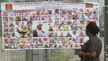Residents read a Nigerian army poster of wanted Boko Haram suspects in Bayelsa, Nigeria