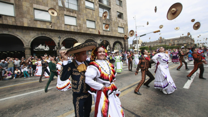 Dancers in traditional outfits throw their hats during a performance as part of the fourth "Jalisco is Culture" festival at Liberacion Square in Guadalajara