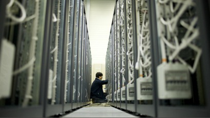 A scientist performs maintenance at a data center