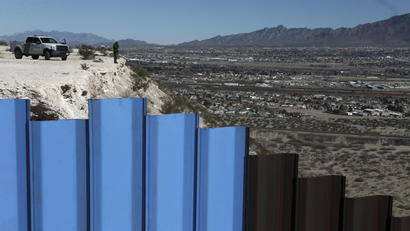 a US border patrol observes the Mexico-US border fence