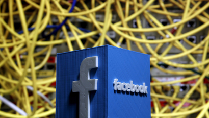 FILE PHOTO: A 3D plastic representation of the Facebook logo is seen in front of displayed cables in this illustration in Zenica