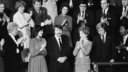 Lennie Skutnik the man who jumped into the Potomac River and saved one of the passengers aboard the Air Florida jetliner that crashed there on January 13 receives applause from first lady Nancy Reagan and his wife at night on Tuesday, Jan. 27, 1982 at House chamber of Capitol Hall in Washington.