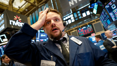 A trader looks confused on the floor of the New York Stock Exchange