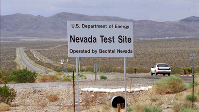 A car drives down a road leading into the Nevada Test Site which eventually could be used by trucks loaded with high-level radioactive waste Thursday, May 30, 1996, in Mercury, Nev. The U.S. Senate passed a bill Wednesday, July 31, 1996, that could make the Nevada Test Site an interim storage facility for radioactive waste.