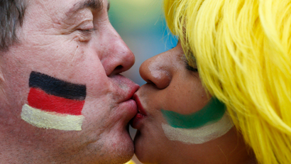 A couple kiss as they wait for the start of the 2014 World Cup semi-finals between Brazil and Germany at the Mineirao stadium in Belo Horizonte July 8, 2014.