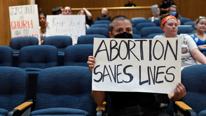 A protesters holds a sing that reads Abortion saves lives