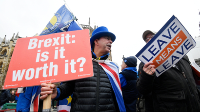 Pro and anti-Brexit protesters argue opposite the Houses of Parliament in London