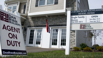 In this photo made on Wednesday, Sept. 10, 2014, signs welcome visitors to a model home as construction is under way at a housing development in Zelienople, Pa. Real estate date provider CoreLogic releases its August report on U.S. home prices on Tuesday, Oct. 7, 2014. (AP Photo/Keith Srakocic)
