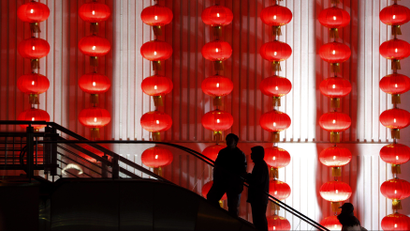 People walk past decorative red lanterns ahead of the New Year celebrations in Shanghai