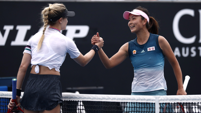 Peng Shuai shakes hands with a fellow tennis player on the court