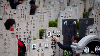 A man cleans the tombstone of a deceased relative during the Qingming Festival, or Tomb Sweeping Day at Songhe graveyard, on the outskirts of Shanghai April 4, 2013. The festival, which falls on April 4 this year, is a day for the Chinese to remember and honour their ancestors. A new service standard aimed at regulating the quality of China's public cemeteries has been launched by the Ministry of Civil Affairs to cope with the country's ageing population, according to Xinhua News Agency. REUTERS/Carlos Barria