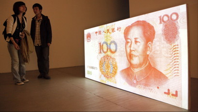Visitors look at the art work by American artist Tony Oursler entitled "100 Yuan (People's Republic of China)" which features a projection of a Chinese renminbi note with a talking Mao Zedong at a gallery in Beijing, China, Thursday, April 8, 2010. U.S. Treasury Secretary Timothy Geithner is expected to press Beijing over its currency controls when he meets a Chinese vice premier in a sign the two sides are stepping up efforts to narrow their differences in the dispute. (AP Photo/Ng Han Guan)