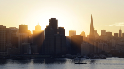 The sun sets behind the city skyline on Wednesday, Jan. 7, 2015, in San Francisco. (AP Photo/Marcio Jose Sanchez)