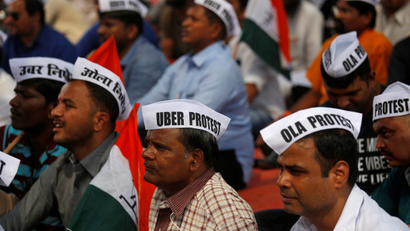 Ola and Uber drivers are seen wearing caps during a protest against Ola and Uber in Mumbai