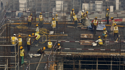 Labourers work at the construction site of a residential complex in Mumbai