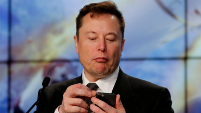 SpaceX founder and chief engineer Elon Musk looks at his mobile phone.