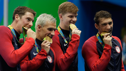 The United States team from left, Conor Dwyer, Ryan Lochte, Townley Haas and Michael Phelps celebrate with their gold medals after the men's 4x200-meter freestyle relay during the swimming competitions at the 2016 Summer Olympics, Wednesday, Aug. 10, 2016, in Rio de Janeiro, Brazil.