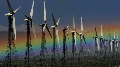 This Jan. 28, 2008 file photo shows a rainbow visible looking West from Palm Springs, Calif. next to an array of wind turbines. Interior Secretary Sally Jewell on Tuesday, Sept. 23, 2014, unveiled a proposed roadmap for developing massive solar and wind projects in California's Mojave Desert.