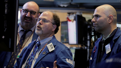 Specialist traders from Citadel LLC and KCG Holdings Inc. work inside a post on the floor of the New York Stock Exchange (NYSE)