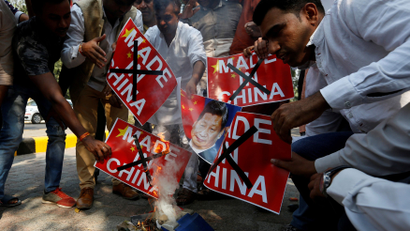 FILE PHOTO: Demonstrators burn Chinese goods and poster of Chinese President Xi, during a protest in New Delhi