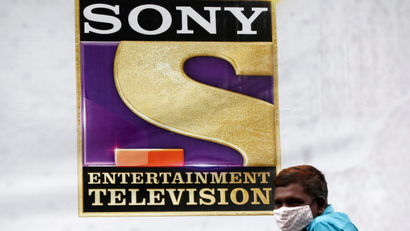 A man stands next to a banner of Sony Entertainment, outside a film set in Mumbai