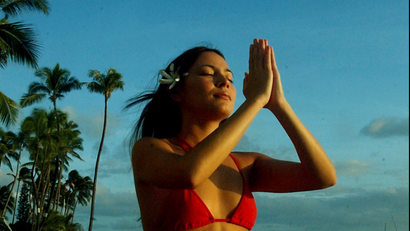 Chanelle Kanani Kukona, 23, of Mililani, ends the day and week with a daily meditation at Queens Surf Beach near Waikiki in Honolulu, Hawaii, June 1, 2003. Kukona is a lomi-lomi practitioner (Hawaiian style massage) and says she likes to meditate daily preferably near the ocean. Picture taken June 1.