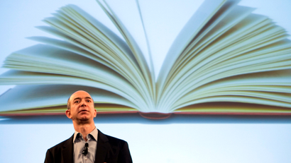 Jeff Bezos, founder and CEO of Amazon.com, uses a projected image of a book to introduce the Kindle at a news conference on Monday, Nov. 19, 2007 in New York. The $399 electronic book device will allow downloads of more than 90,000 book titles, blogs, magazines and newspapers.