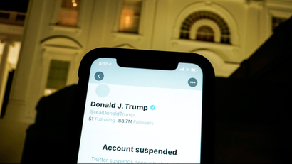 FILE PHOTO: A photo illustration shows the suspended Twitter account of U.S. President Donald Trump on a smartphone and the White House in Washington