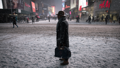 A man stands in falling snow on West 42nd street in Times Square in New York, January 26, 2015. The National Weather Service (NWS) issued a blizzard warning for New York City and surrounding areas on Monday, and warned of two days of winter storms across the East Coast, from Pennsylvania to Maine. REUTERS/Mike Segar (UNITED STATES - Tags: ENVIRONMENT TPX IMAGES OF THE DAY) - RTR4N1C7