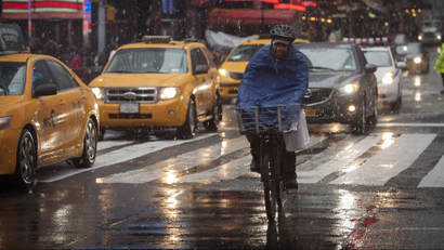 A bike delivery man cycles through New York.