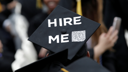 A graduating student of the CCNY wears a message on his cap during the College's commencement ceremony in the Harlem section of Manhattan, New York