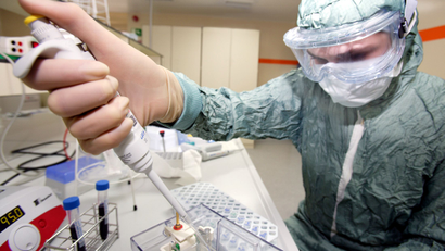 A handout file photo shows a technician preparing specimens from a master H1N1 virus sample, for the pre-production of a vaccine against pandemic influenza A (H1N1) virus at a laboratory of GlaxoSmithKline in Dresden June 16, 2009. The pandemic of H1N1 swine flu has been a bonus for GlaxoSmithKline, which makes the inhaled flu drug Relenza, a vaccine and special antiviral masks, the company said July 23, 2009. Relenza is one of two drugs approved for use against H1N1. Picture taken June 16, 2009