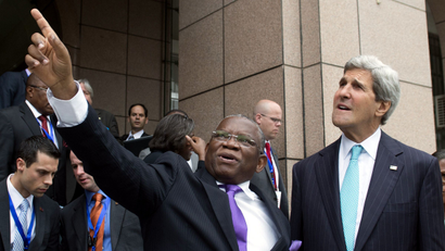 Foreign Minister Georges Rebelo Chicoti of Angola, left, shows US Secretary of State John Kerry nearby government buildings following meetings at the Ministry of Finance in Luanda, Angola, May 5, 2014. Kerry on May 4 praised oil-rich Angola's leadership role in efforts to solve long-drawn conflicts on the African continent.
