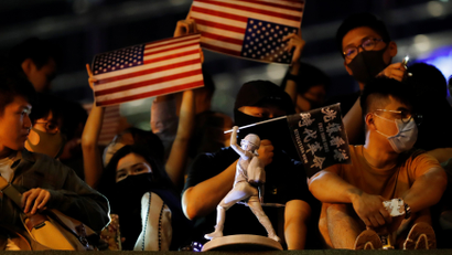 Anti-government demonstrator holds U.S. flags in Hong Kong.
