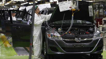 In this April 18, 2011 photo, workers give the final checkup on the cars of Honda Accord Tourer at Honda Motor Co.'s Saitama Factory in Sayama, north of Tokyo, Monday, April 18, 2011 as the Japanese automaker resumed limited production on April 11 at the factory following the March 11 earthquake and tsunami. Honda said Thursday, April 28, 2011 its quarterly profit dropped 38.3 percent due to a slump in car production following last month's disasters.