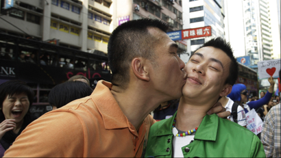 Gay participants, Wesley Poon, left, kisses his friend Tim Lee of Hong Kong during a gay rally in Hong Kong Saturday, Dec. 13, 2008. Hundreds of gay supporters, from various lesbian, gay and bisexual transgender communities marched as fighting for their rights.