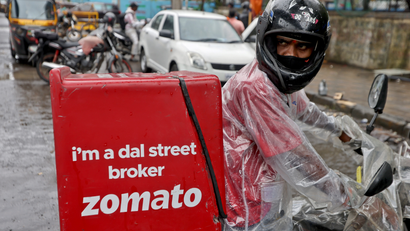 A delivery worker of Zomato leaves to pick up an order from a restaurant in Mumbai