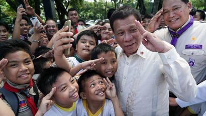 Philippine President Rodrigo Duterte interacts with members of the Boy Scouts of the Philippines who attended the National Heroes Day Commemoration at the Libingan ng mga Bayani in Fort Bonifacio, Taguig City, metro Manila, Philippines August 28, 2017. Malacanang Presidential Palace/Handout