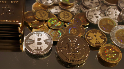 Bitcoins created by enthusiast Mike Caldwell are seen in a photo illustration at his office in Sandy, Utah, September 17, 2013. Caldwell produces physical coins Bitcoins, which have been around since 2008, are a form of electronic money that can be exchanged without using traditional banking or money transfer systems. REUTERS/Jim Urquhart
