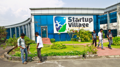 Employees stand outside the Start-up Village in Kinfra High Tech Park in Kochi
