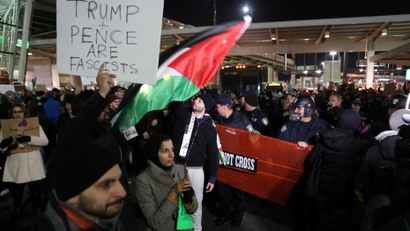 Police corral protesters who gathered in opposition to U.S. President Donald Trump's ban on immigration and travel outside Terminal 4 at JFK airport in Queens