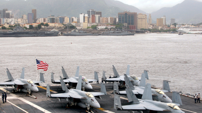 F-18 Super Hornet fighter airplanes sit on the deck of the USS Carl Vinson aircraft carrier at Guanabara Bay in Rio de Janeiro February 26, 2010. The aircraft carrier USS Carl Vinson arrived in Brazil on Friday, a few weeks after taking part in Operation Unified Response, the international humanitarian aid mission in Haiti. The ship stopped in Rio de Janeiro on its way to dock in San Diego, California.