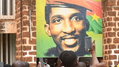 A color banner of Thomas Sankara hangs from a wall