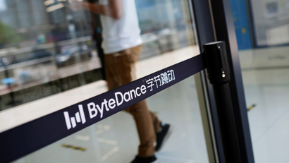 Man walks by a logo of Bytedance, which owns short video app TikTok, at its office in Beijing