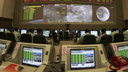 In this photo taken Tuesday, Dec. 10, 2013 and made available Thursday, Dec. 12, 2013, researchers work in the control room of the Chang'e 3 lunar probe at the Beijing Aerospace Control Center in Beijing, China. China's lunar probe Chang'e 3 entered an orbit closer to the moon on Tuesday and will attempt a landing in the coming days in a bid to become the third country to do so after the United States and the former Soviet Union. (AP Photo)