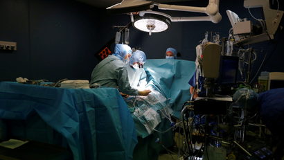 A heart surgeon, with members of a medical team perform an operation in an operating room at the Saint-Augustin clinic in Bordeaux